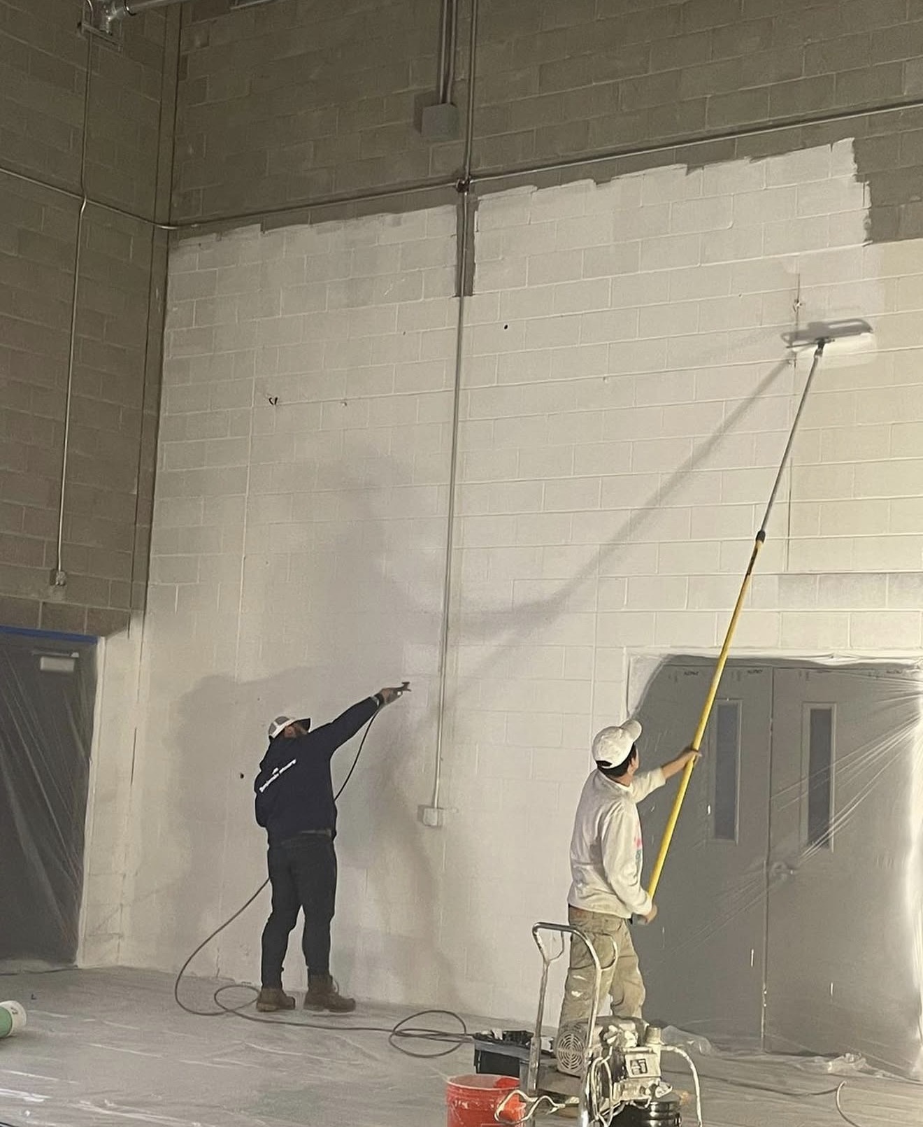 Two Painters Painting Interior Walls