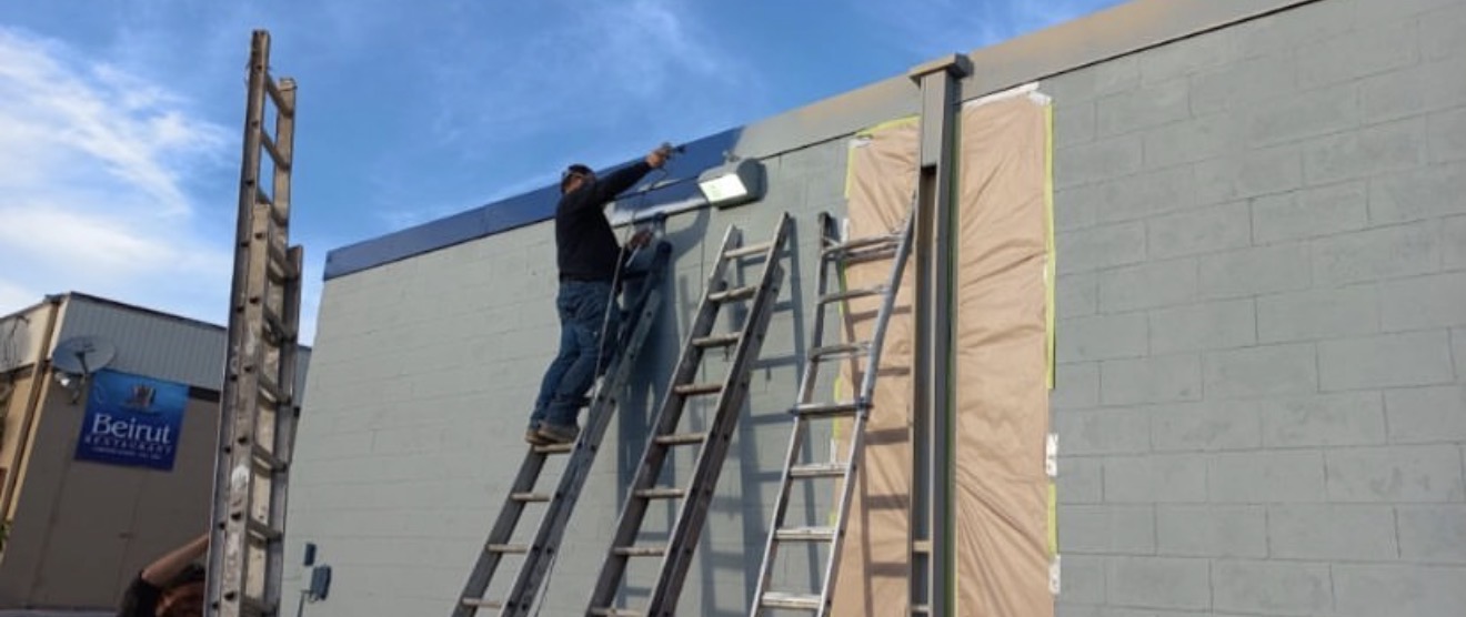 Man Painting Exterior Commercial Building